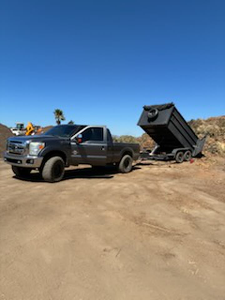 Dump trailer raised to unload a full load of hauled junk