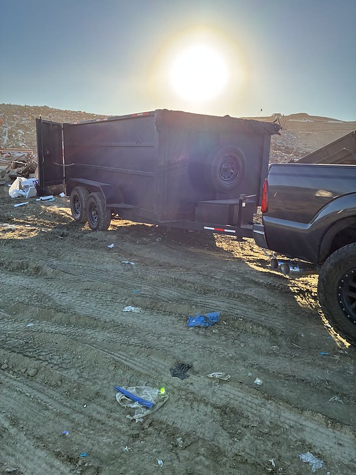 JC's dump trailer and truck at the landfill after a full junk removal load